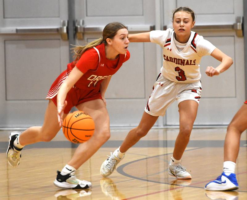 Oregon's Addison Rufer (11) drives to the basket as Forreston's Tenlei Patterson (3) defends during a Saturday, Jan. 3, 2026 game at Forreston High School.