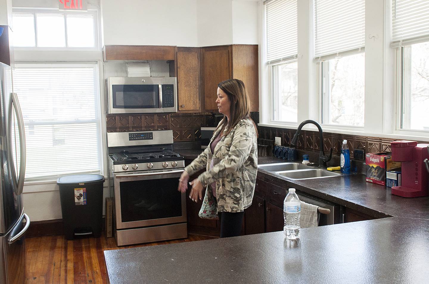 Sarah Kent talks about the kitchen in the home she grew up in during an open house Saturday, April 16, 2022. The home has been converted into a sober living facility by Sauk Valley Voice of Recovery. “I am really excited to see how they have renovated the house.” Kent said