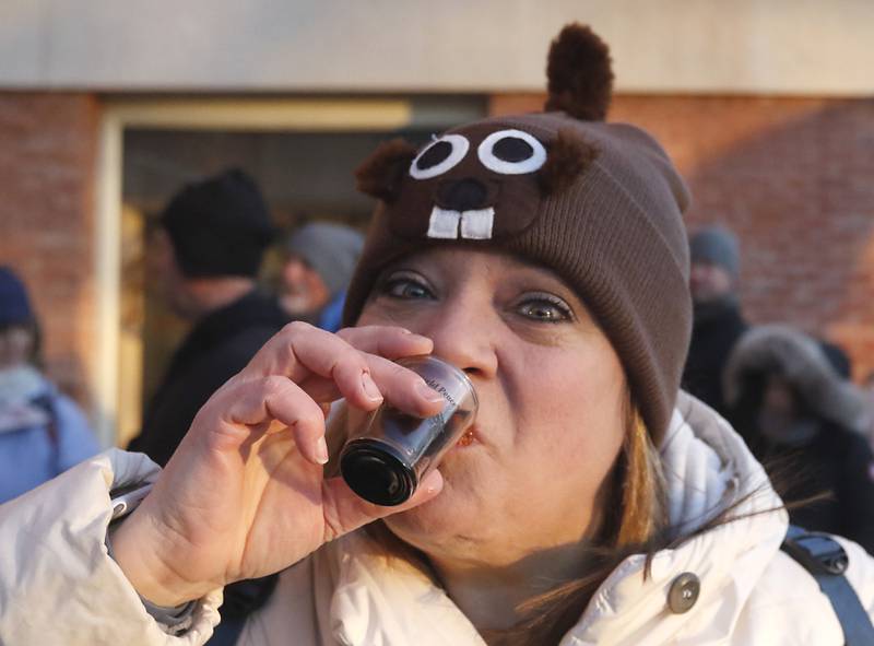 Amanda Weller of Woodstock drinks to world peace at Public House of Woodstock on Thursday, Feb, 2, 2023, during the annual Groundhog Day festivities on the Woodstock Square.