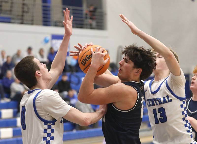 Cary-Grove's Brady Elbert tries to drive between Burlington Central's Patrick Magan (left) and eclan Wilson (right) during a Fox Valley Conference boys basketball game on Friday, February. 6, 2026, at Burlington Central High School.