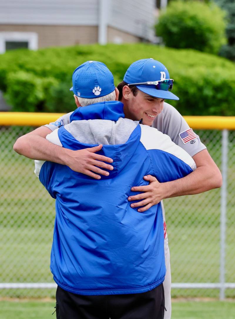 Princeton senior Noah LaPorte hugs Tiger coach Wick Warren, who is retiring after 10 years at the Tigers helm, after Monday's 5-2 regular-season ending loss to Kewanee.