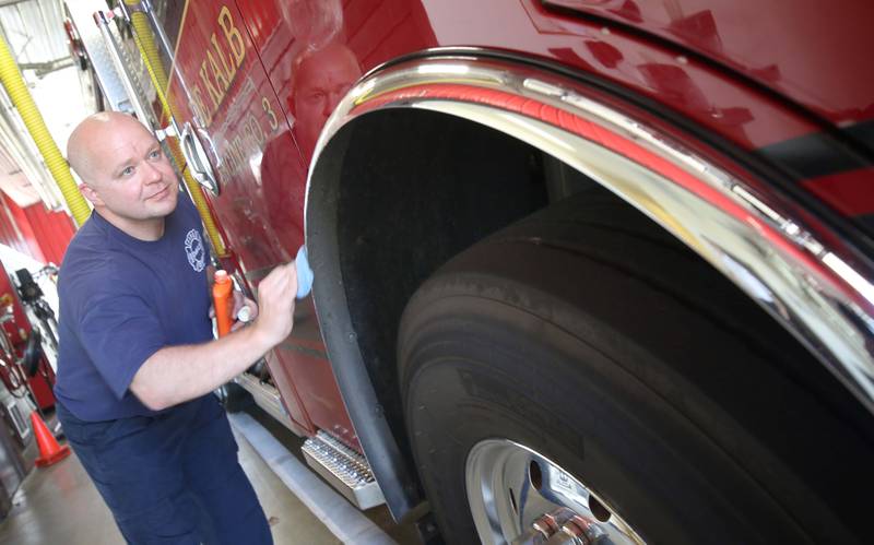 DeKalb firefighter Andrew Romano waxes the departments newest engine Tuesday, May 16, 2023, in the apparatus bay at Fire Station 3 in DeKalb.