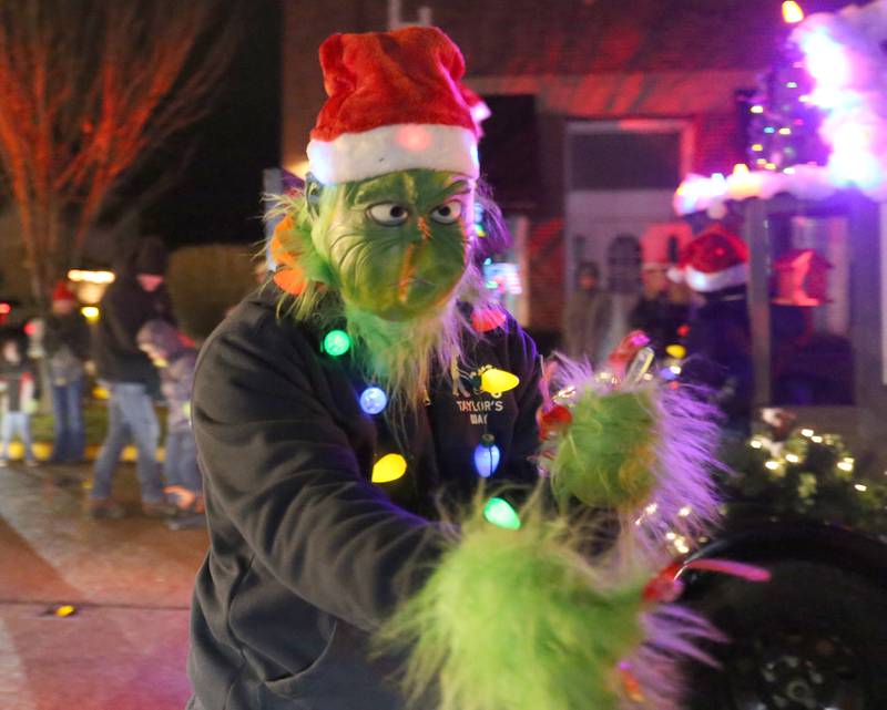 The Grinch walks down Main Street in the inaugural Lighted Christmas Parade on Friday, Dec. 1, 2023 in Princeton.