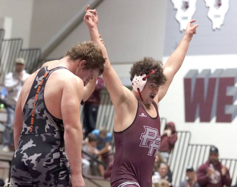 Prairie Ridge’s Frank Matviychuk celebrates a win at 215 pounds over McHenry’s Henry Mitchell in varsity boys wrestling on Thursday, Jan. 8, 2026 at Prairie Ridge High School in Crystal Lake.