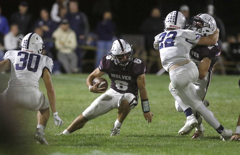 Prairie Ridge's Luke Vanderwiel cuts between Cary-Grove's Landon Moore (left) and Michael Dunkin (right) during a Fox Valley Conference football game on Friday, Sept. 27, 2024, at Prairie Ridge High School.