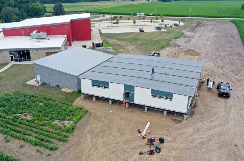 Crews install four 70 x 70 modular classrooms on the new property next to Waltham School on Monday, July 8, 2024 in Utica. The school, built in 2018, has already outgrown its 240 student capacity and placed the four classrooms next to the school.