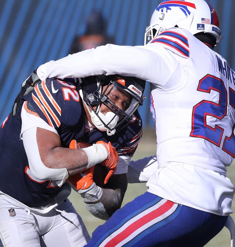 Chicago Bears running back David Montgomery tries to break the tackle of Buffalo Bills cornerback Tre'Davious White during their game Sunday, Dec. 24, 2022, at Soldier Field in Chicago.