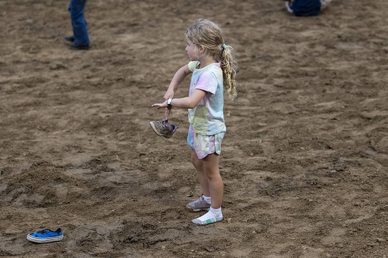 Parker Misfeldt, 4, of Erie takes her time putting on her shoes during the kid’s race Wednesday, August 14, 2024, at the Whiteside County Fair in Morrison.