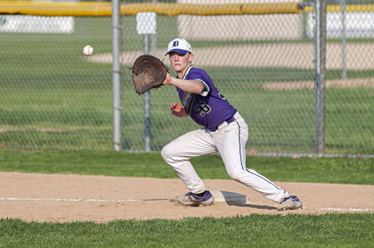 Dixon’s Quentin Seggerbruch catches a ball at first for an out against North Boone Thursday, May 12, 2022.