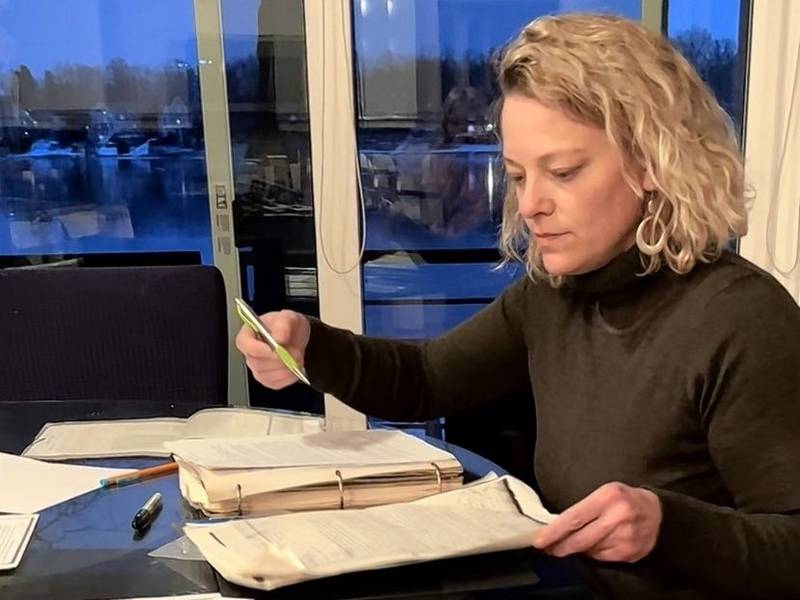 Mundelein-area resident and Crystal Lake native Nicole Sullivan looks over documents related to her property. She is the first Lake County resident to ask a restrictive covenant be stricken from property records.