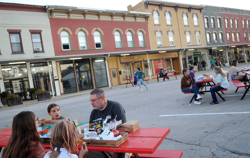 Steve Carpenter, his daughter Chloe, 11 and friends Rosie, 8 and Ciara, 11 enjoy food during the Taste of Sandwich, Wednesday, Sept. 25, 2024, in downtown Sandwich.