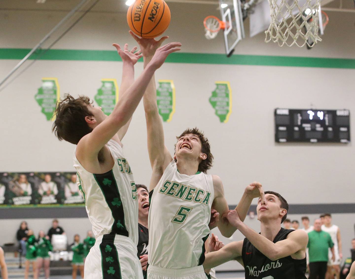 Seneca's Brady Sheedy and teammate Sebastian Deering grab a rebound over Woodland's Jaron Follmer on Friday, Feb. 14, 2025 at Seneca High School.