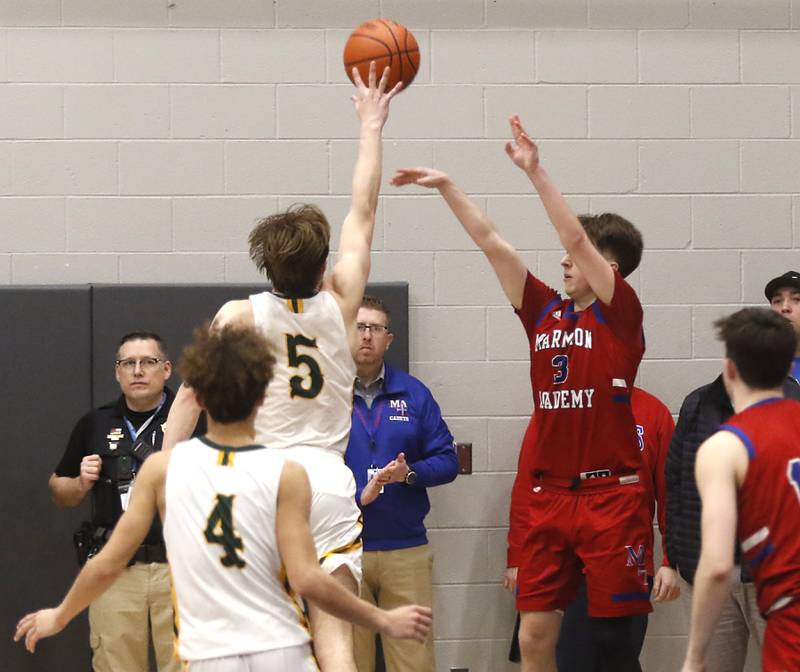 Marmion’s Collin Wainscott shoots a three-pointer over Crystal Lake South's Brady Schroeder in the final minute of the game during a IHSA Class 3A Sectional boys basketball game Tuesday, Feb. 28, 2023, at Central High School in Burlington.