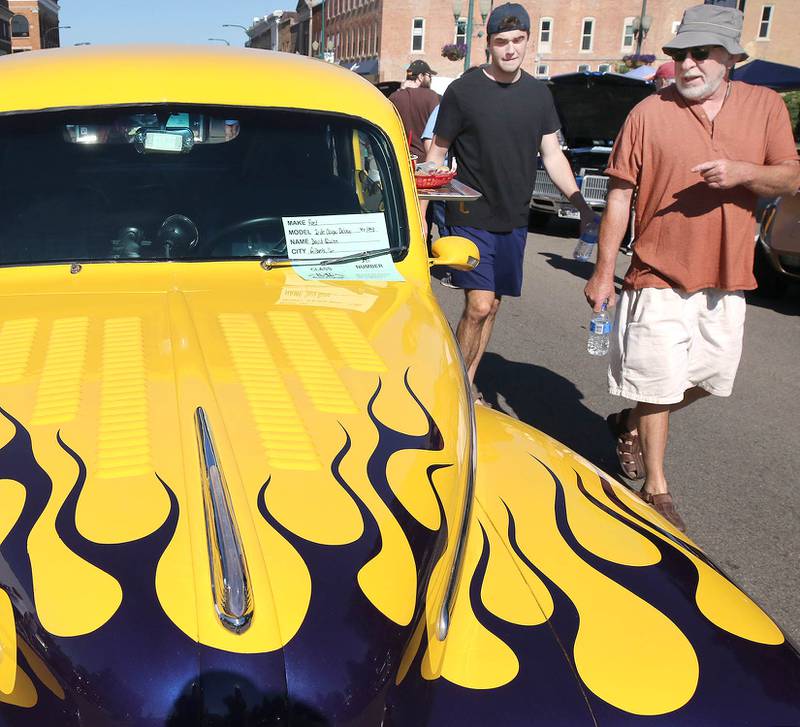 Visitors check out a 1948 Ford two-door Coupe Deluxe on State Street in Sycamore Sunday, July 31, 2022, during the 22nd Annual Fizz Ehrler Memorial Car Show.