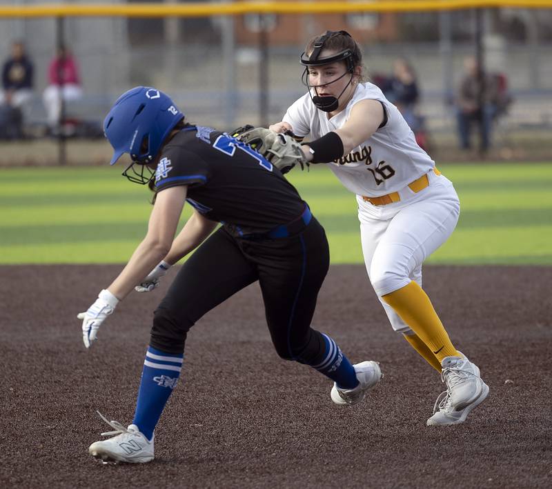 Newman’s Anna Propheter is tagged out trying to steal second by Sterling’s Breanna Taylor Tuesday, March 18, 2025.