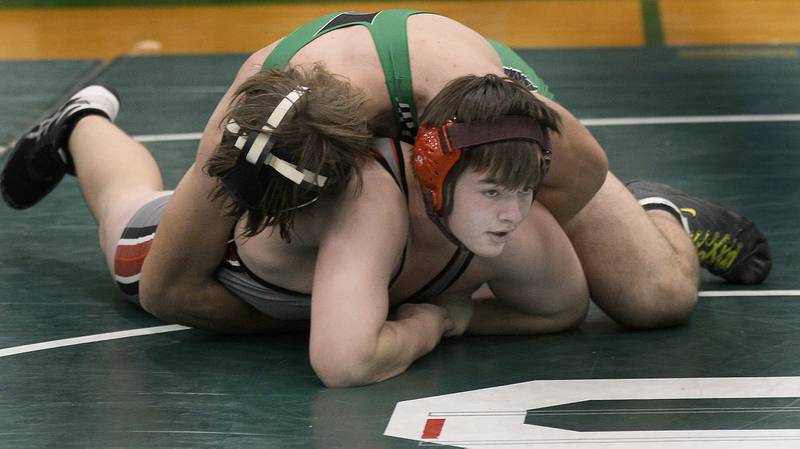 Ottawa’s Ryan Wilson works to get out from under Seneca’s Chris Peura in the 195 weight class championship match Saturday, Dec. 3, 2022 at Seneca.