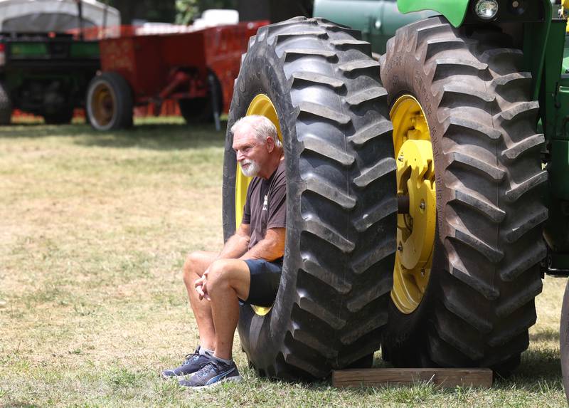 A spectator finds a good seat to watch the tractors go by Thursday, Aug. 8, 2024, during the 67th annual Sycamore Steam Show and Threshing Bee at Taylor Marshall Farm.