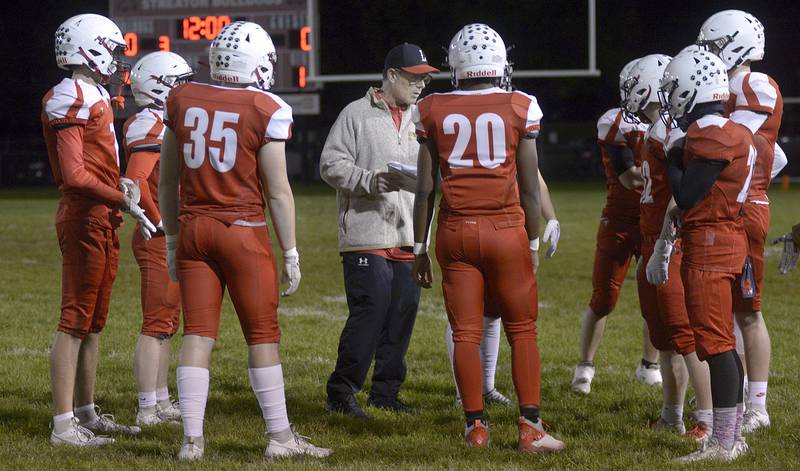 The Streator Bulldogs go over the game plan from the coaching staff between 1st and 2nd quarter against Wilmington Friday at Streator.