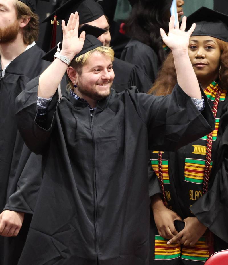 A Northern Illinois University candidate for graduation waves to family at the beginning of the first of two undergraduate commencement ceremonies Saturday, May 11, 2024, in the Convocation Center at NIU in DeKalb.