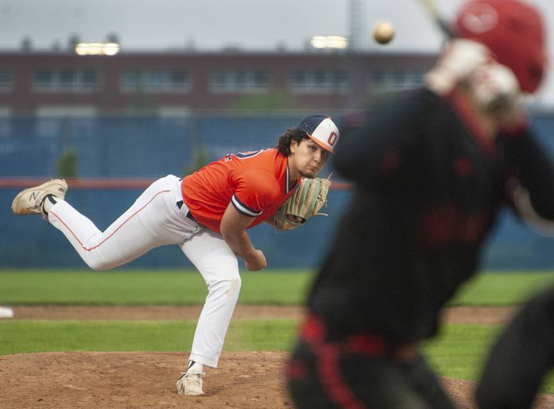 Oswego pitcher Jordan Logan hurls the ball toward a Yorkville batter during a varsity boys baseball game on Wednesday, May 18, 2022 at Oswego High School.