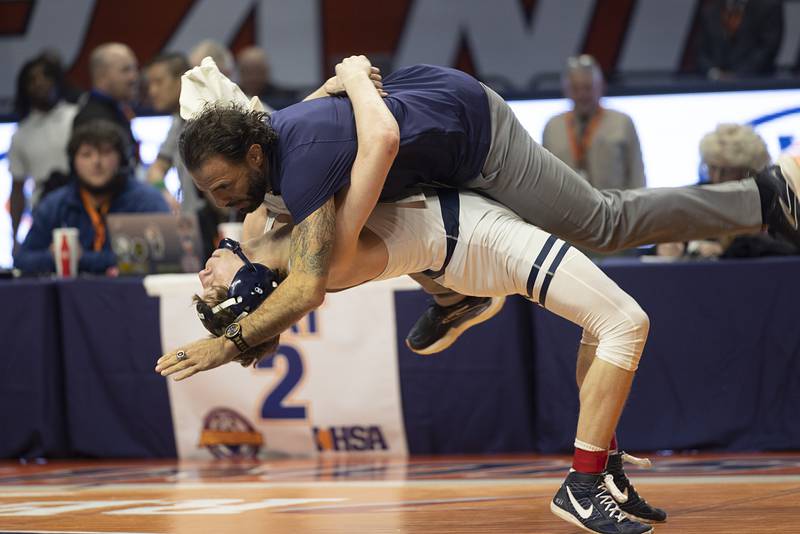 IC Catholic’s Aiden Arnett slams his coach after winning the 2A 150 pound title Saturday, Feb. 21, 2026, at the IHSA wrestling finals in Champaign.