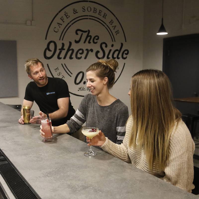 Chris Jacob talks with Eva Powers and Courtney Jayhan Friday, Oct. 28, 2022, at the Other Side Cafe and Sober Bar, 135 Beardsley St. in Crystal Lake. Chris Reed, who opened the first sober bar in Crystal Lake many years ago, is opening a new one in downtown Crystal Lake. The first bar closed two years ago.