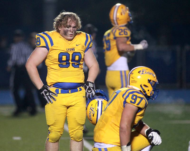 Lyons Township players show their disappointment following their 17-14 loss in the Class 8A second round football playoff game against York in Western Springs on Saturday, Nov. 4, 2023.