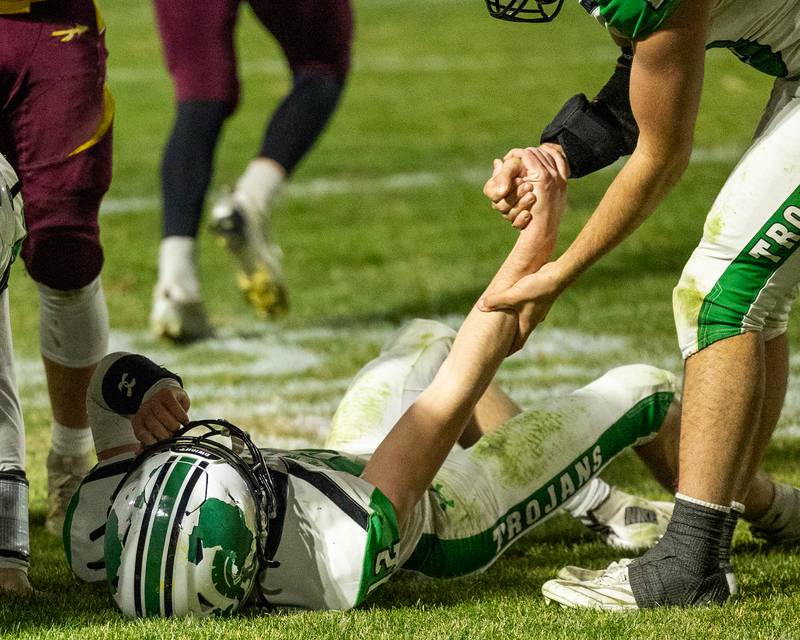 Asher Kargle (12) of Dwight is helped up by teammate after being tackled on Saturday, November 15, 2025 at John O' Boyle Field in Stockton.