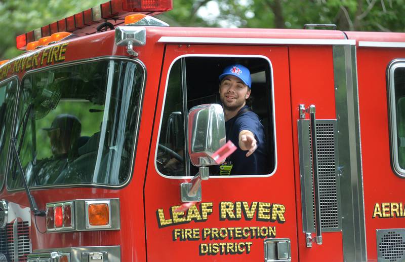 A Leaf River firefighter tosses candy to the crownd during Leaf River Daze Parade in Leaf River on Sunday, June 8, 2025.