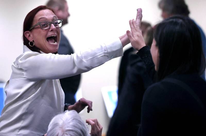 Amy “Murri” Briel, Democratic candidate in the 76th District state representative race high-fives DeKalb mayoral candidate Linh Nguyen Tuesday, Nov. 5, 2024, at the election night watch party at River Heights Golf Club in DeKalb.