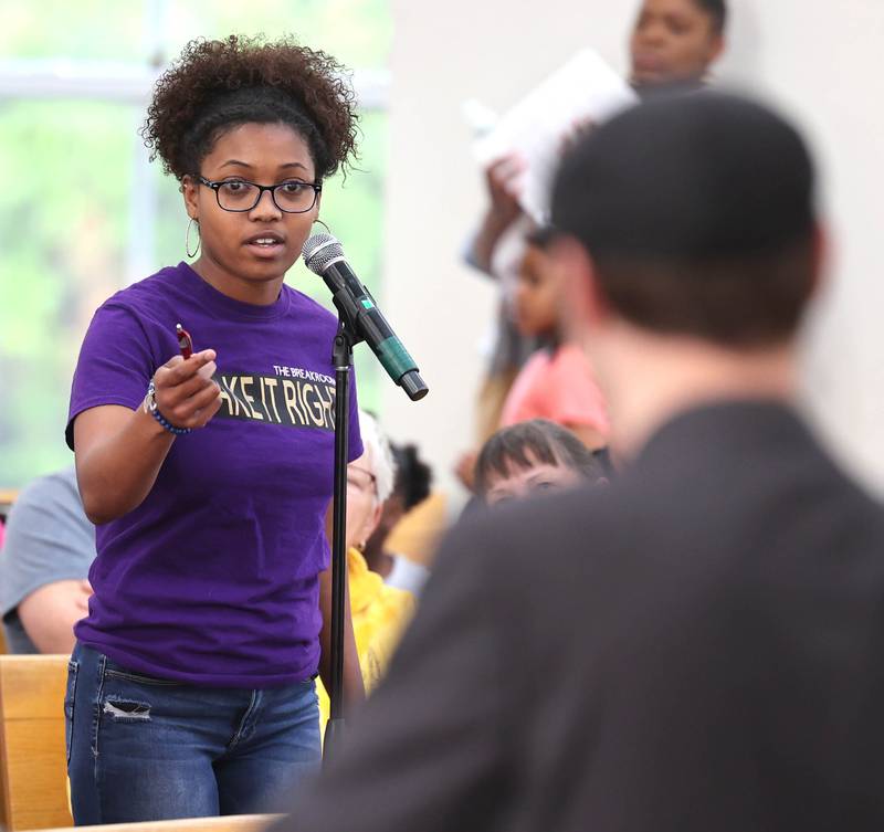 Malia James, from DeKalb, asks a question of Clint-Michael Reneau, vice president for student affairs at Northern Illinois University, after he spoke about the proposed NIU Center for Greek Life during the informational meeting Thursday, May 18, 2023, at New Hope Missionary Baptist Church in DeKalb. The meeting centered on the the proposed plans for the vacant lot on the corner of Blackhawk Road and Hillcrest Drive in DeKalb.