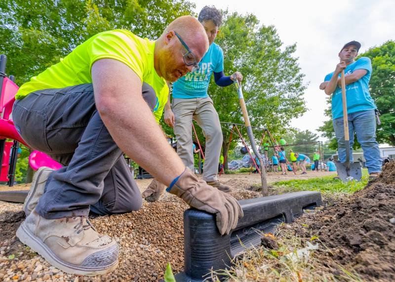 Michael Hince installs a retaining wall around the playground at Ray Barto Memorial Park on June 3, 2025 in Seatonville.