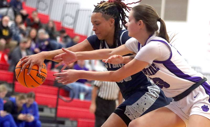 Hampshire’s Jesslyn Mack, front, and South Elgin’s Liv Miller battle for the ball in varsity girls basketball Komaromy Classic tournament  action on Monday, Dec. 29, 2025, at Dundee-Crown High School in Carpentersville.