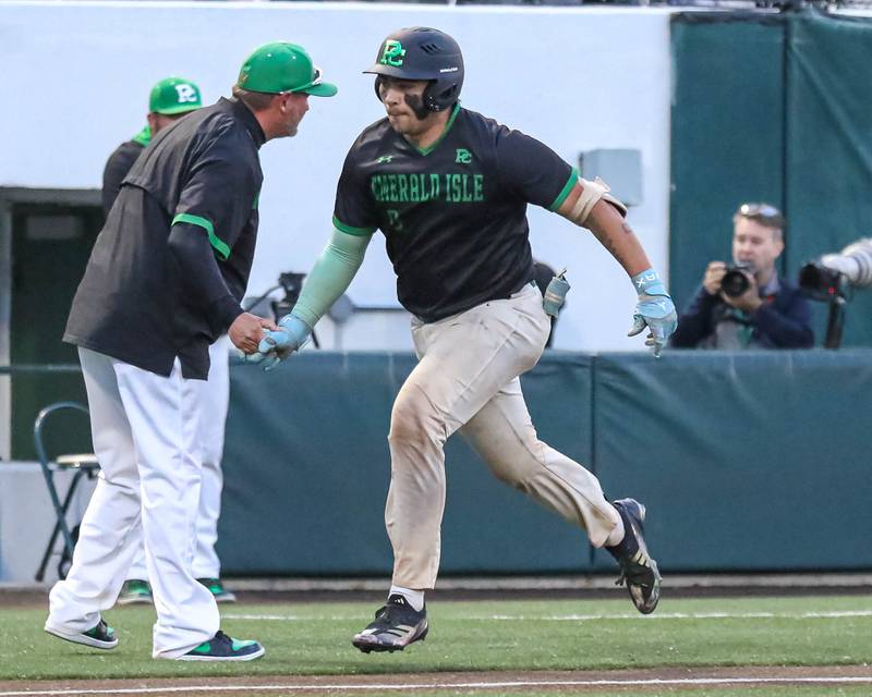 Providence Catholic's Enzo Infelise (9) is greeted by head coach Mark Smith as he rounds third after hitting a homerun during Class 4A super sectional baseball game between Providence at Brother Rice. Monday, June 9, 2025 in Crestwood.
