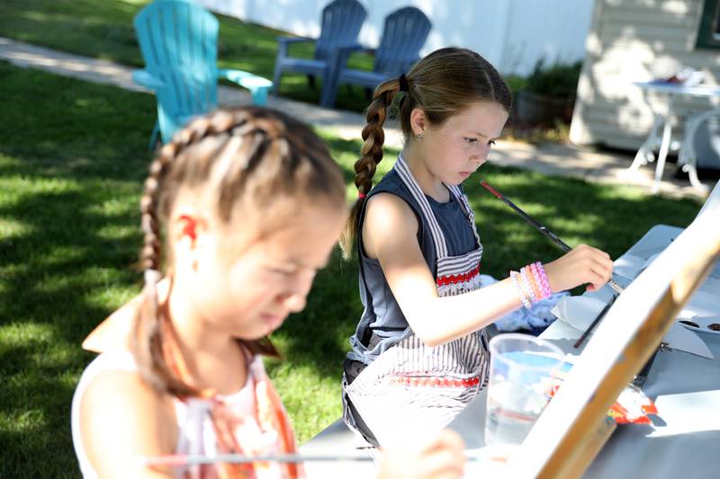 Gretchen Kuang, 7, (left) and Lillian Fowler, 9, both of Sycamore, work on their paintings of horses during a painting class with Chelsea McGhee Studios at the Little Cottage on the Farm in Kaneville on Thursday, July 27, 2023.