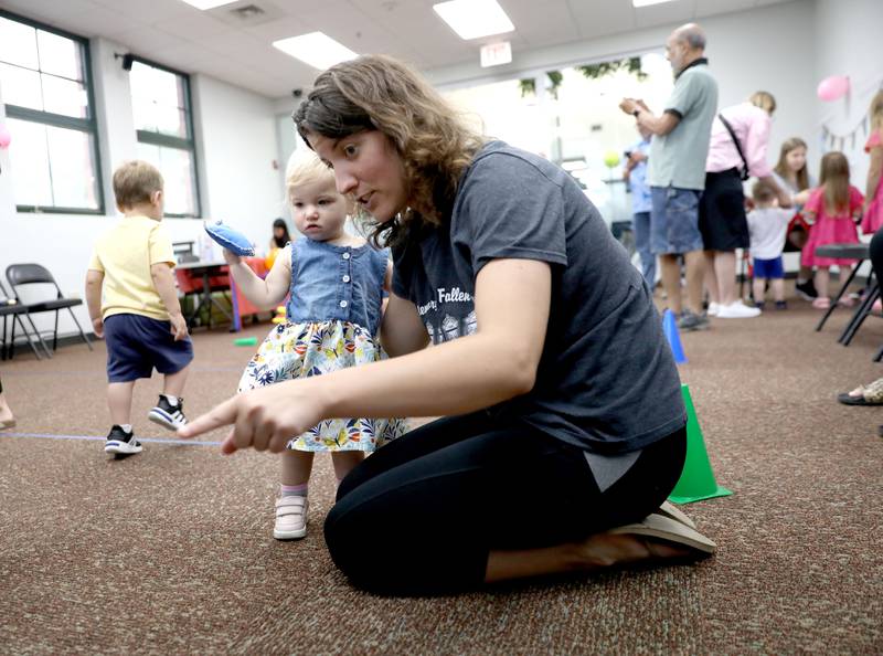 Annemarie O’Neil of Willowbrook and her daughter, Gianna, 1, play a game during a Paw Patrol party at the Indian Prairie Public Library in Darien on Friday, June 28, 2024.