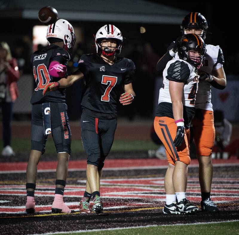 Bradley-Bourbonnais' Issac Allison, center, tosses the ball off after a touchdown run in a game against Dekalb on Friday, October 10, 2025.