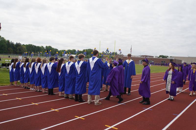 Rochelle Township High School graduating seniors walk to the football field on Saturday, May 23, 2026.