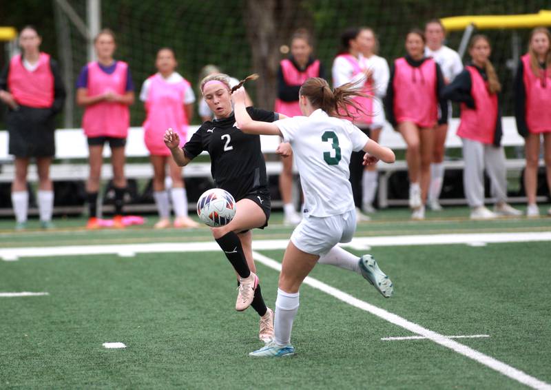 Wheaton Warrenville South's Sarah Alman kicks the ball away from Glenbard West's Lily Hubbuch during a Class 3A Glenbard West Sectional semifinal game on Tuesday, May 27, 2025 in Glen Ellyn.