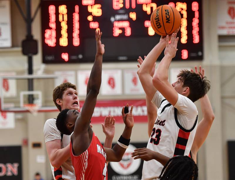 Benet’s Edvardas Stasys (23) scores with a putback during a game against Marist on Friday, Dec. 13, 2024 at Benet Academy in Lisle.