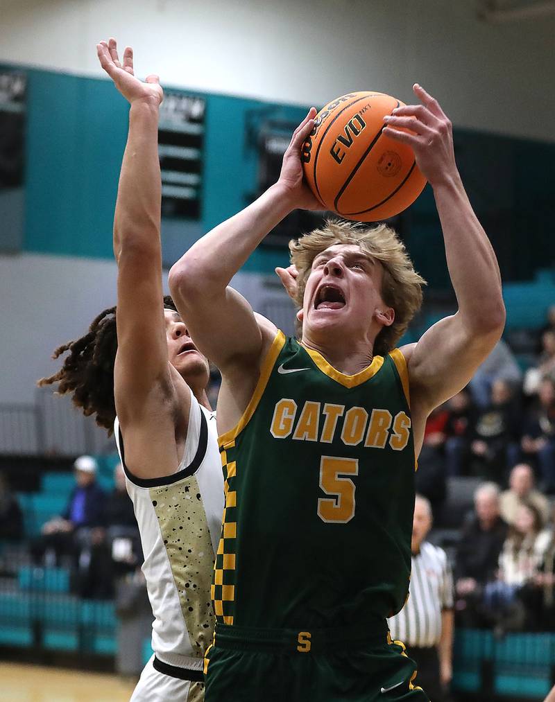 Crystal Lake South's Carson Trivellini shoots the ball in front of Sycamore's Josiah Mitchell during an IHSA Class 3A Woodstock North Sectional semifinal.basketball game on Wednesday, March 4, 2025, at Woodstock North High School.