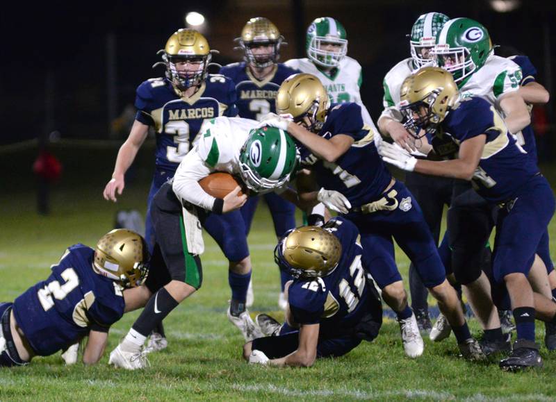Marco defenders contain an Alden-Hebron player during 8-man playoff action against on Friday, Nov. 1, 2024 in Polo.