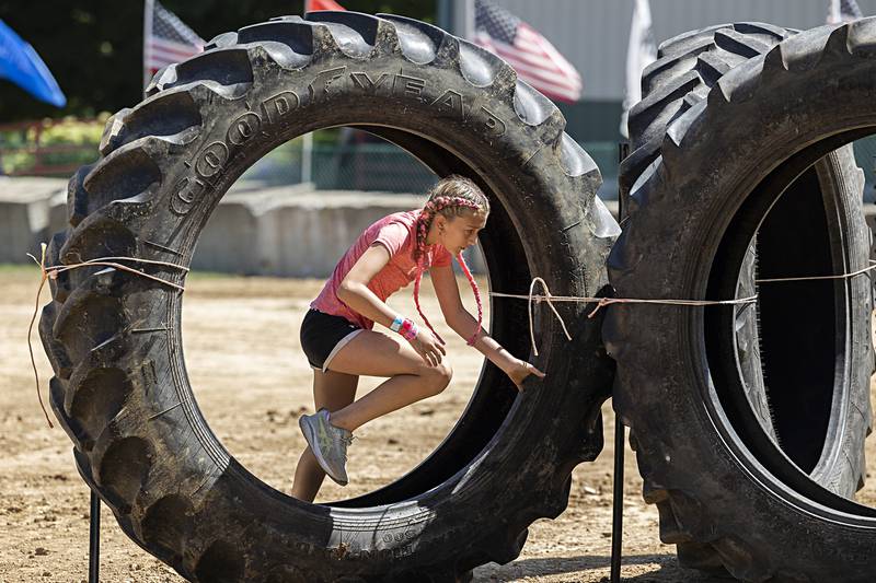 Emma Buyers, 13, of Milledgeville zips through one of three tires Saturday, Aug. 10, 2024 on the Ninja Farmer course at the Carroll County Fair.