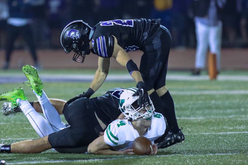 York's Sean Winton (4) looses his helmet while being tackled by Downers Grove North's Ethan Kist (23) during football game between York at Downers Grove North.  Sept 29, 2023.