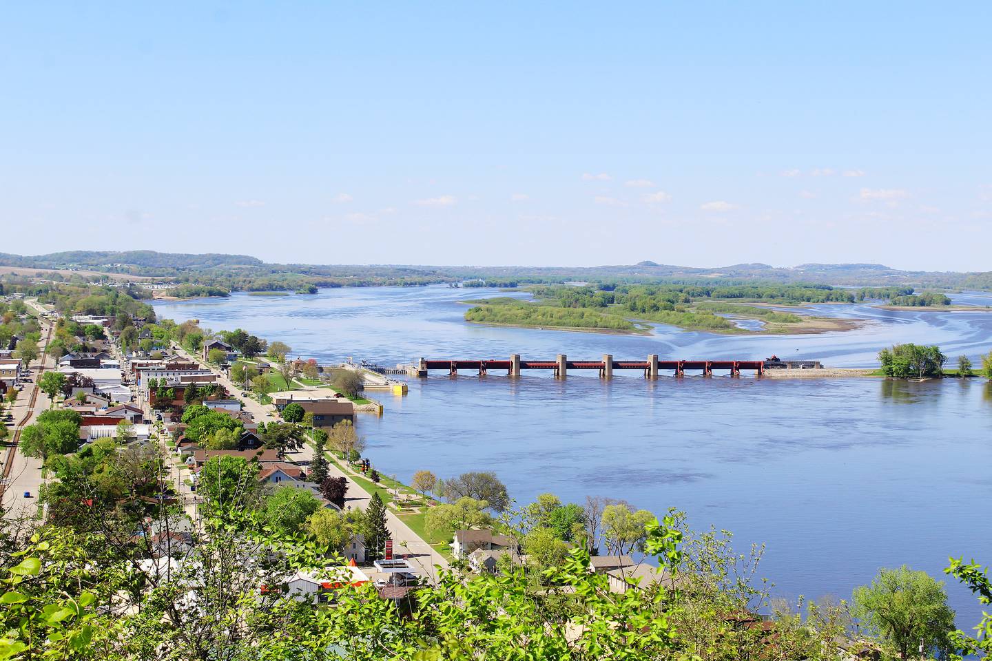 Lock and Dam No. 12 in Bellevue, Iowa, on the Mississippi River, was built between 1934-38. It's one of 29 located between Minneapolis-St. Paul and St. Louis. Around 12,000 barges pass through each year (around 30 a day). The dam's public access area has a raised platform, accessible by stairs, that give sightseers views of the river, dam, and boats that pass by. A boat launch is nearby, south of the dam.