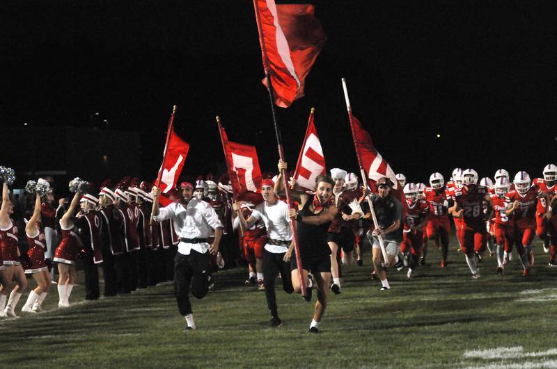 The Ottawa football team runs onto King Field before their homecoming game against Sycamore on Friday, Sept. 26, 2025.