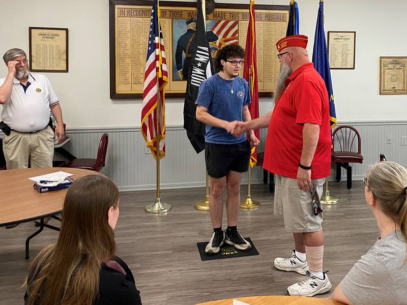 Nathanial Evans, of Minooka (left) shakes hands with Marine Corps. League Commandant Jeff Alexander. Evans leaves for basic training in the Marines in August.