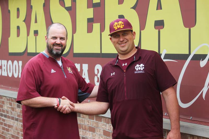Montini Catholic High School Athletic Director Brian Casey (from left) congratulates Eric Scott, newly named head baseball coach.