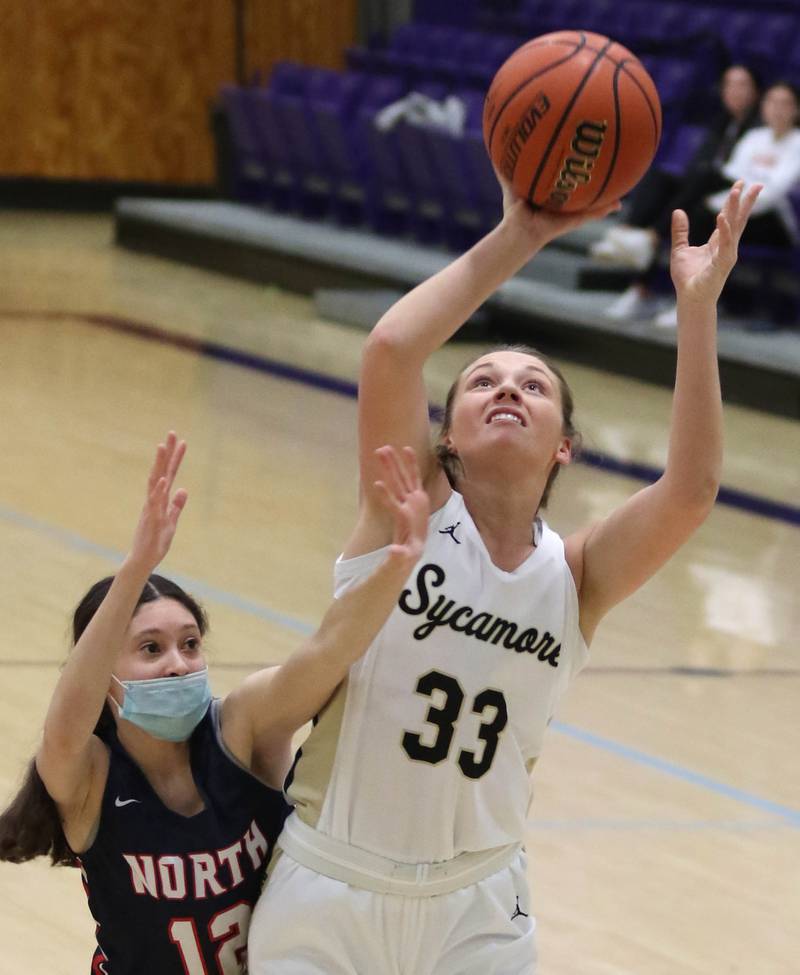 Sycamore's Ella Shipley shoots over Belvidere North's Josy Ostalaza during their IHSA regional final game Thursday, Feb. 17, 2022, at Rochelle High School.