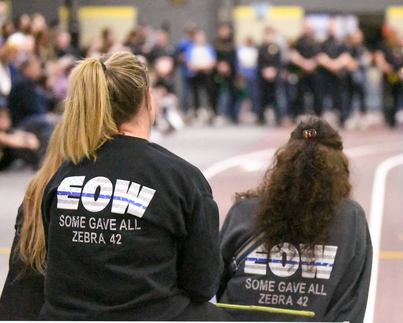 Community members wear EOW "End Of Watch" shirts during the a memorial vigil for the late DeKalb County Sheriff's Deputy Christina Musil on Saturday, March 29, 2025, at the Sycamore High School Field House. Musil was killed in the line of duty in a car crash while on patrol on March 28, 2024.